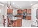 Well-appointed kitchen with granite countertops, stainless steel appliances, tile backsplash, and kitchen island seating at 2425 E Flintlock Dr, Gilbert, AZ 85298