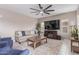 Cozy living room featuring comfortable seating, ceiling fan, and TV is perfect for relaxation and entertainment at 2425 E Flintlock Dr, Gilbert, AZ 85298