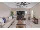 Inviting living room with plush sofa, a ceiling fan, and a mounted television for ultimate relaxation at 2425 E Flintlock Dr, Gilbert, AZ 85298