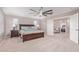 Spacious primary bedroom with carpet floors, neutral walls, ceiling fan, and ensuite bathroom at 2425 E Flintlock Dr, Gilbert, AZ 85298