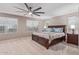 Spacious primary bedroom featuring carpet floors, neutral walls and a ceiling fan at 2425 E Flintlock Dr, Gilbert, AZ 85298