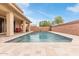 Large pool with tiled decking and a covered patio, perfect for outdoor entertaining and relaxation at 2425 E Flintlock Dr, Gilbert, AZ 85298