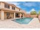 Spacious backyard featuring a large swimming pool, covered patio, and ample seating areas for outdoor relaxation at 2425 E Flintlock Dr, Gilbert, AZ 85298