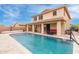 Exterior of home showcasing a large swimming pool, covered patio and second story view at 2425 E Flintlock Dr, Gilbert, AZ 85298