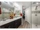 Elegant bathroom with double sinks, a marble countertop, updated fixtures, and a glass-enclosed shower at 2425 W Bronco Butte Trl # 1056, Phoenix, AZ 85085