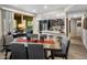 Contemporary dining area with wood table, seating for six, and an open layout flowing into the kitchen at 2425 W Bronco Butte Trl # 1056, Phoenix, AZ 85085