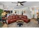 Open-concept living area with a leather sectional, stylish rug, and seamless flow into the modern kitchen at 2425 W Bronco Butte Trl # 1056, Phoenix, AZ 85085