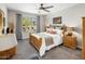Cozy main bedroom with natural light, plush carpeting, a comfortable bed, and stylish decor at 2425 W Bronco Butte Trl # 1056, Phoenix, AZ 85085