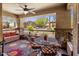 Relaxing outdoor patio with comfortable seating, ceiling fan, and views of the surrounding community landscape at 2425 W Bronco Butte Trl # 1056, Phoenix, AZ 85085