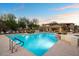 Serene community pool with clear blue water, lounge chairs, and well-maintained landscaping at 2425 W Bronco Butte Trl # 1056, Phoenix, AZ 85085