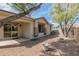 A view of the low maintenance backyard featuring desert landscaping and a covered patio at 2701 S Southwind Dr, Gilbert, AZ 85295