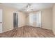 Bright bedroom featuring wood-style tile flooring, a ceiling fan and an open bathroom with shower at 2701 S Southwind Dr, Gilbert, AZ 85295