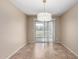 Sunny dining area with sliding glass door access to the backyard and modern lighting at 2701 S Southwind Dr, Gilbert, AZ 85295