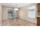 Sunny dining area with sliding glass door access to the backyard and modern lighting at 2701 S Southwind Dr, Gilbert, AZ 85295