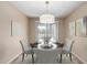 Staged dining area with modern chandelier and seating for four for a warm, inviting feel at 2701 S Southwind Dr, Gilbert, AZ 85295