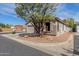 Street view of a well maintained single-story home with a tidy yard and large shade tree at 2701 S Southwind Dr, Gilbert, AZ 85295