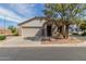 Charming single-story home with a two-car garage, a neutral color palette, tree and a tile roof at 2701 S Southwind Dr, Gilbert, AZ 85295