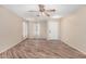 Bright living room featuring wood-look tile floors and a ceiling fan for added comfort at 2701 S Southwind Dr, Gilbert, AZ 85295