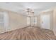 Bright living room featuring wood-look tile floors and a ceiling fan for added comfort at 2701 S Southwind Dr, Gilbert, AZ 85295