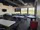 Large meeting room with multiple tables, chairs, and a view of the outdoor space at 2701 S Southwind Dr, Gilbert, AZ 85295