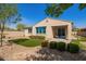 Manicured backyard featuring artificial grass, desert landscaping and a covered patio at 2792 N Acacia Way, Buckeye, AZ 85396