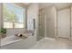 Bright bathroom with a soaking tub, shower and large window providing natural light and fresh views at 2792 N Acacia Way, Buckeye, AZ 85396
