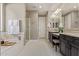 A bright bathroom features a soaking tub, shower and vanity with double sinks at 2792 N Acacia Way, Buckeye, AZ 85396
