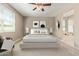 Inviting staged bedroom showcasing a plush bed, ceiling fan, and natural light from the window at 2792 N Acacia Way, Buckeye, AZ 85396