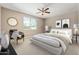 Serene staged bedroom featuring a comfortable bed, ceiling fan, and a decorative chair at 2792 N Acacia Way, Buckeye, AZ 85396