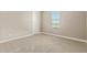 Bright bedroom with a window for natural light, and a neutral-colored carpet at 2792 N Acacia Way, Buckeye, AZ 85396