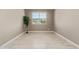 Minimalist bedroom design with wood-look floors, neutral walls, and a sunlit window at 2792 N Acacia Way, Buckeye, AZ 85396