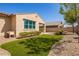 Exterior view of the home featuring a well-kept lawn and desert landscaping at 2792 N Acacia Way, Buckeye, AZ 85396