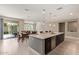 Open-concept kitchen and dining space with stainless steel appliances and a bright, airy feel at 2792 N Acacia Way, Buckeye, AZ 85396