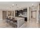 Well-equipped kitchen with dark cabinetry, an island with seating, and modern pendant lighting at 2792 N Acacia Way, Buckeye, AZ 85396
