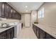 Laundry room with cabinets, countertops, sink, washer, and dryer at 2792 N Acacia Way, Buckeye, AZ 85396