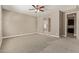 A large bedroom featuring an ensuite bath visible through an archway, with lots of open space at 2792 N Acacia Way, Buckeye, AZ 85396