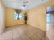 Bright bedroom features neutral walls, tiled flooring, ceiling fan, and natural light at 3108 W Butler Dr, Phoenix, AZ 85051