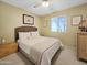 Cozy bedroom featuring a woven headboard, neutral decor, and natural light at 3108 W Butler Dr, Phoenix, AZ 85051