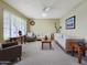 Bright living room with plush seating, ceiling fan, and large window bringing natural light to this spacious home at 3108 W Butler Dr, Phoenix, AZ 85051