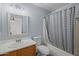 Bathroom with wooden cabinetry and a shower and bath combo at 3122 W Dunbar Dr, Phoenix, AZ 85041