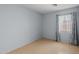 Clean bedroom with a window and hardwood-style flooring at 3122 W Dunbar Dr, Phoenix, AZ 85041