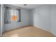 Bright bedroom with a window, light blue walls, and wood-look flooring at 3122 W Dunbar Dr, Phoenix, AZ 85041
