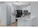 Bright kitchen with white cabinets, quartz countertop, stainless appliances, and a stylish mosaic backsplash at 3122 W Dunbar Dr, Phoenix, AZ 85041