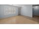 Clean living room featuring shuttered windows, neutral paint, and hardwood floors at 3122 W Dunbar Dr, Phoenix, AZ 85041