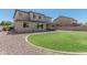 Beautifully landscaped backyard featuring a lush green lawn, modern patio area, and gravel at 3528 E Tonto Dr, Gilbert, AZ 85298