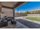 Inviting backyard patio features a modern seating set and lush green landscaping at 3528 E Tonto Dr, Gilbert, AZ 85298