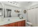 Bright bathroom featuring a large mirror, decor, single sink vanity, and tiled floors at 3528 E Tonto Dr, Gilbert, AZ 85298