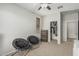 A serene bedroom featuring two comfortable chairs, a storage chest and a closet at 3528 E Tonto Dr, Gilbert, AZ 85298