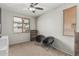 This bedroom has carpet flooring, a window with blinds, and two black chairs at 3528 E Tonto Dr, Gilbert, AZ 85298