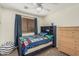 Bedroom with carpet, window, blinds, curtains, a fan and dresser at 3528 E Tonto Dr, Gilbert, AZ 85298